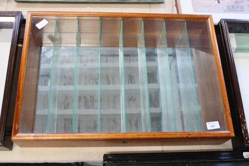 A glazed wooden dealers display cabinet with glass partition...