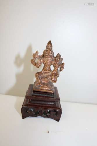 A Chinese Tibetan bronze & copper Buddha on a carved wooden ...