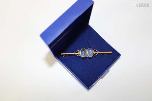 An antique 9ct gold & moonstone bar brooch