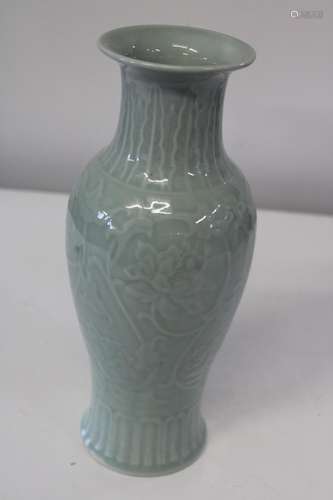 A Chinese celadon glazed vase decorated with flowers, signed...