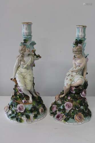 A near pair of Dresden porcelain candle sticks. Sold as seen...