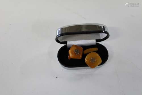 A pair of vintage egg yolk amber cufflinks