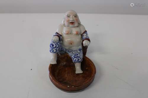 A Chinese seated pottery Budha figure with marks to the base...