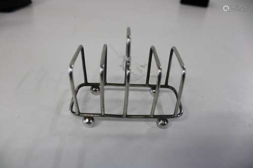 A hallmarked silver four slice toast rack Sheffield 1902 9x8...