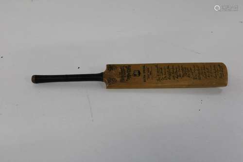 A vintage minature box wood cricket bat with facsimilie sign...