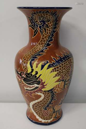 A large decorative vase with dragon decoration. Sold as seen...