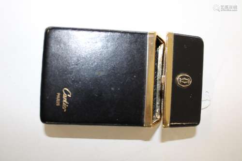 A Cartier black leather cigarette case, sized to accept a re...