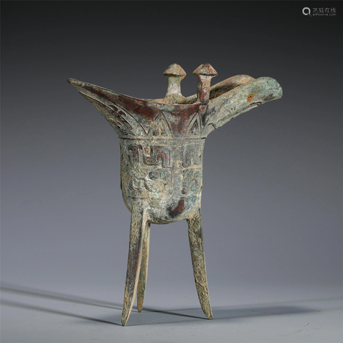 A CHINESE BRONZE TRIPOD JUE WINE VESSEL