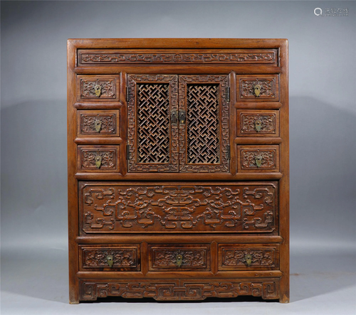 A CHINESE HOLLOW CARVED HUANGHUALI CABINET