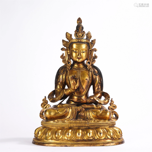 A GILT-BRONZE CROWNED BUDDHA