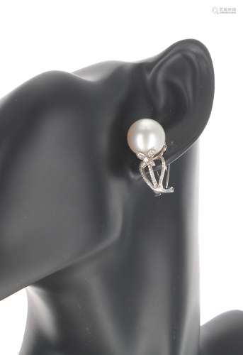 Pair of 18k white gold pearl and diamond earrings, the pearl...