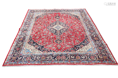 A FINELY WOVEN PERSIAN MASHAD CARPET, the red ground