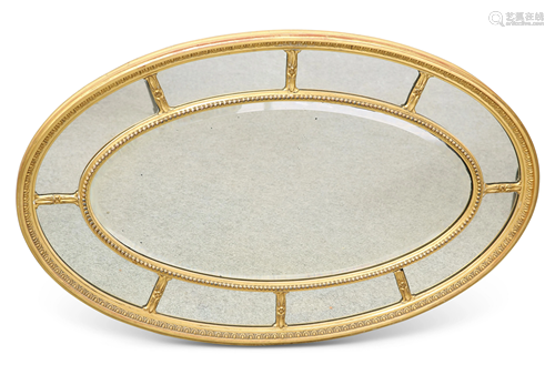 AN 18TH CENTURY STYLE GILT-GESSO OVAL MIRROR, the