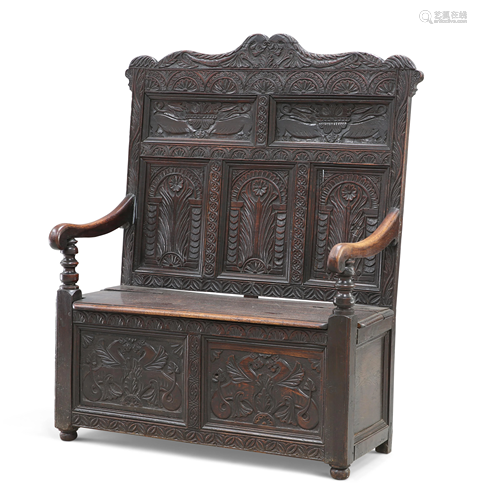 A VICTORIAN CARVED OAK BOX SETTLE, the carved and