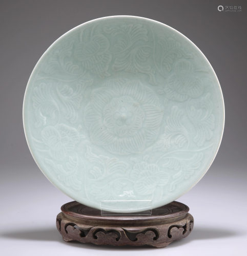 A CHINESE CELADON DISH, circular, carved floral