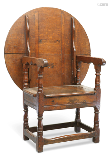 AN OAK MONK'S BENCH, with hinged circular table-top and