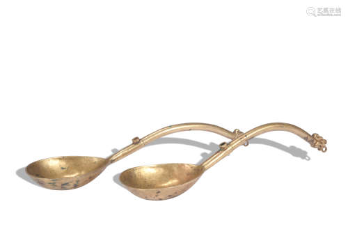 A pair of bronze spoon