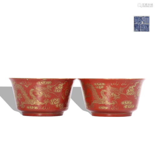 A pair of red glazed 'dragon' cup