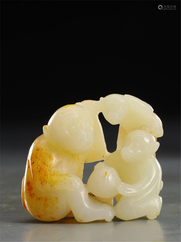 A JADE DECORATION CARVED WITH MONKEYS AND PEACHES