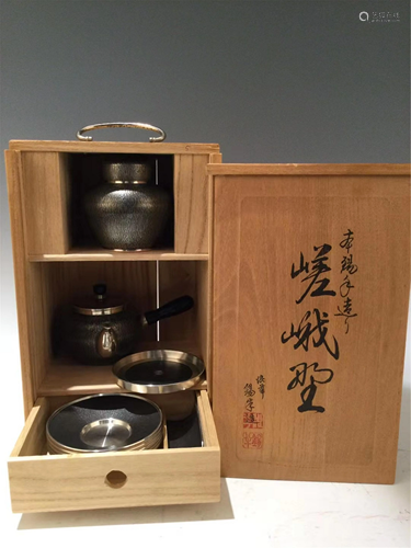 A SET OF JAPANESE TIN TEA WARE AND WOODEN CABINET