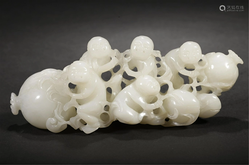 A JADE DECORATION CARVED WITH MONKEYS AND PEACHES