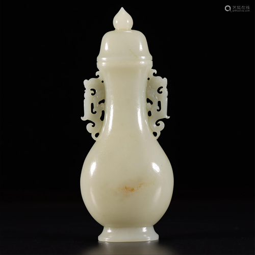 A CARVED DOUBLE-HANDLED JADE VASE AND COVER