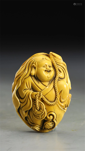 A CARVED FIGURE STORY DECORATION