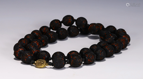 A STRING OF CHINESE CARVED LACQUER PRAYER BEADS