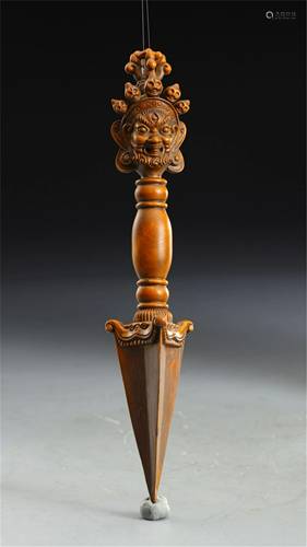 A HARDWOOD CARVED BUDDHIST INSTRUMENT