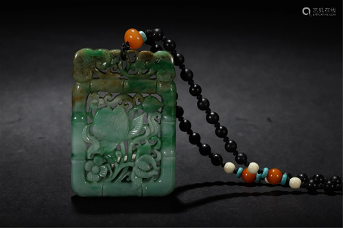 A HOLLOW CARVED JADEITE FLORAL PENDANT