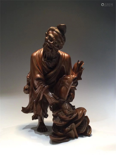 A HARDWOOD CARVED FIGURAL DECORATION