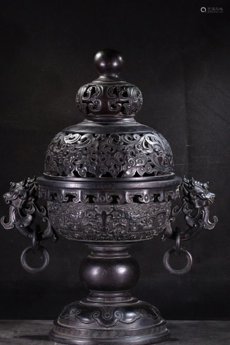 A CARVED HARDWOOD CENSER WITH BEAST HANDLES