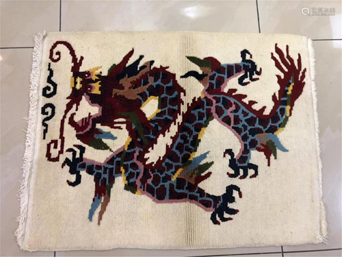 A CREAM-COLORED GROUND DRAGON WOOLEN TAPESTRY