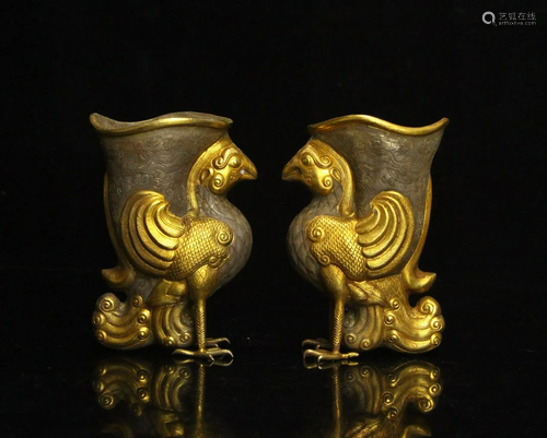 A pair of partial gilt phoenix bird cups from the Tang