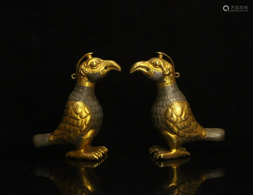 A pair of partial gilt phoenix birds from the Tang