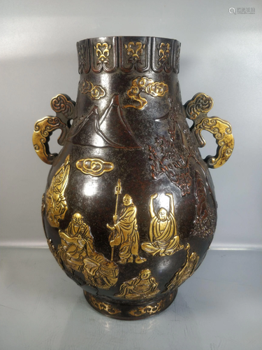 A gilt bronze vase with eighteen arhats, one weighs