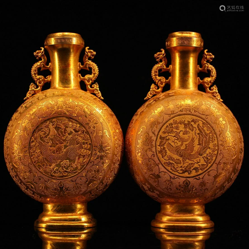 The collection of a pair of hand-engraved gilt dragon