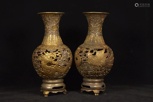 A pair of partially gilt hollow dragon and phoenix