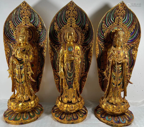 A set of three sacred Buddhas, enamel dotted, gilt