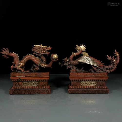 A pair of gilt and silver dragons and phoenixes in the