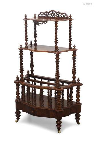 A Victorian walnut Canterbury whatnot, with three serpentine...