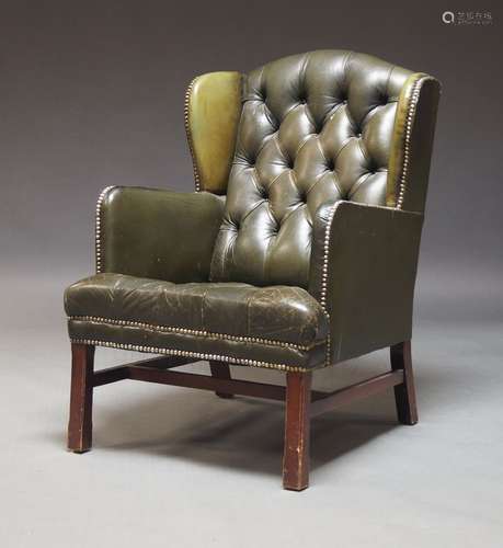 A George III style wingback armchair, 20th Century, upholste...