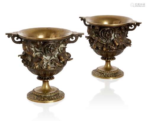 A pair of French bronze urns, c.1880, the bodies cast with p...