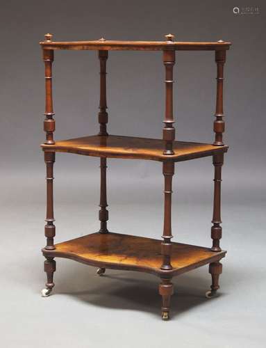 A Victorian walnut three-tier whatnot, with three serpentine...