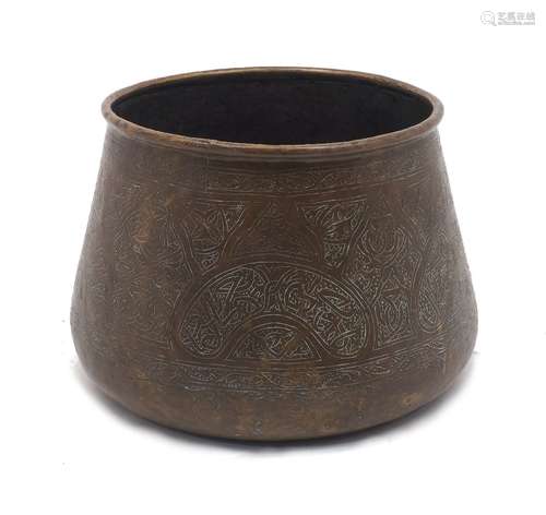 A Middle Eastern incised brass bowl, hammered and engraved b...