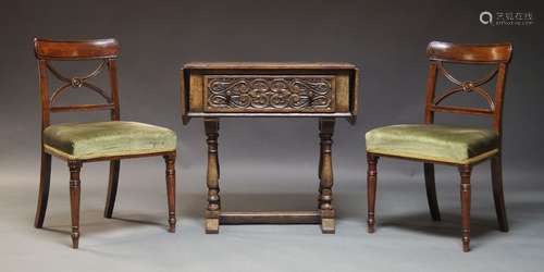 A carved oak hall table, early 20th Century, the rounded rec...