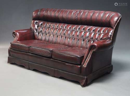 A burgundy leather button back sofa suite, late 20th Century...