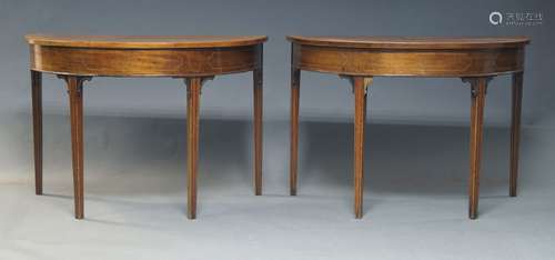 A pair of Georgian style mahogany demi lune tables, 20th Cen...