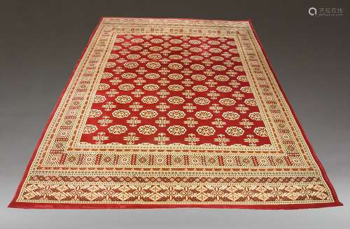 A Bokhara design carpet, of recent manufacture, with rows of...