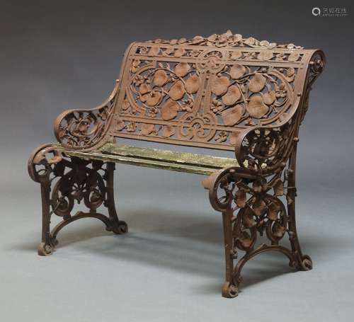 A cast iron bench, early 20th Century, the pierced backrest ...